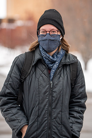 Students smiling with masks around campus on a snowy afternoon at BYUI during the Covid pandemic.