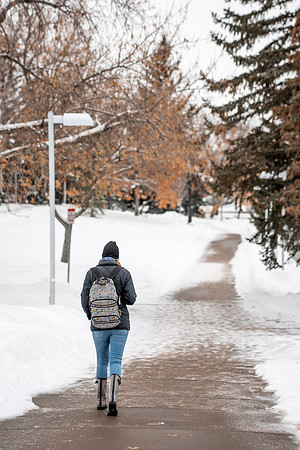 Students smiling with masks around campus on a snowy afternoon at BYUI during the Covid pandemic.