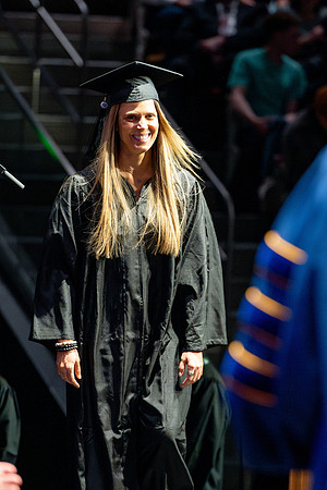 Graduates walk across the stage.