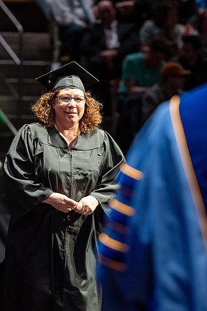 Graduates walk across the stage.
