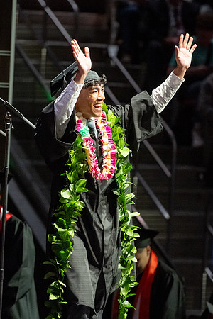 Graduates walk across the stage.