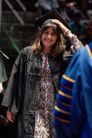 Graduates walk across the stage.