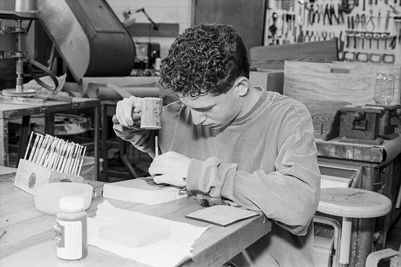 Woodworking student works diligently on the details of his piece. Jan 1993.