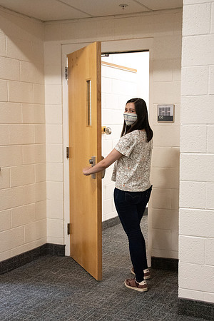 Examples of students staying safe and healthy during the COVID-19 pandemic by social distancing, following pathway arrows, and wearing face masks.