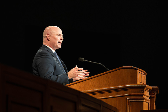 William Riggins addresses students in the I-Center for his devotional address.