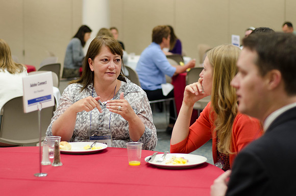 Online instructors gather for breakfast and instruction.