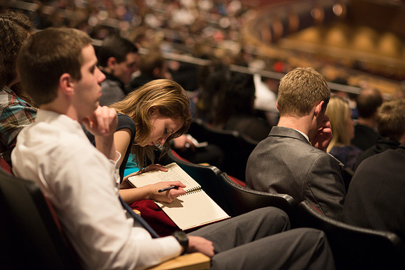 Students listen to Randal L. Ridd and take notes during the World Wide Devotional.