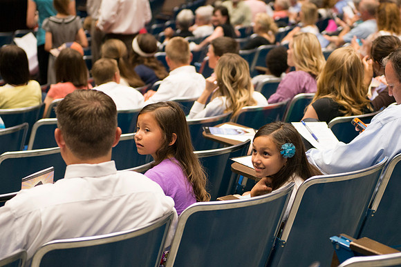 Audience members gather in auditorium for the preformance.