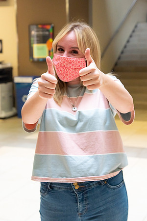 Examples of students staying safe and healthy during the COVID-19 pandemic by social distancing, following pathway arrows, and wearing face masks.