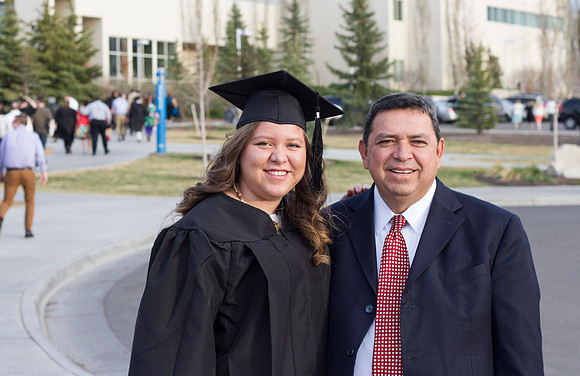 During the 2014 Winter Semester Graduation, a graduate poses with her father outside the BYU-I I-Center. Photo by Tyler Rickenbach