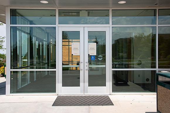 Signs on doors stating they are entrance only. Specific doors are for entrance and exit only in efforts to help fight the COVID-19 virus.