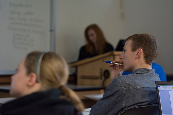 A student in Sister Jenson's Criminology class, carefully observes the movie, "Packing Heat," that was shown in class.