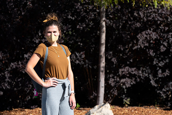 Examples of students staying safe and healthy during the COVID-19 pandemic by social distancing, following pathway arrows, and wearing face masks.