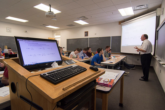 Brother Johanson discusses with his Precalculus class, problems that they will be solving.