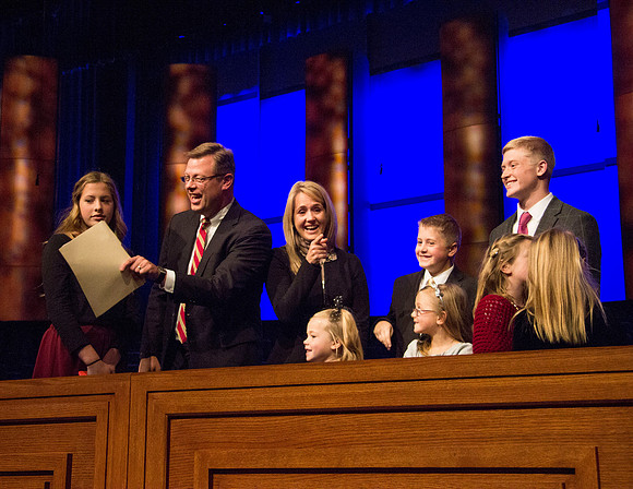 Clark G. Gilbert and his family on the podium after todays devotional. Taken by Erik Hill.