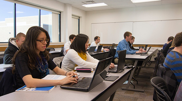 Students listen and take notes as Brother Kevin Packard teaches Intermediate Financial Accouting in the Smith Building.
