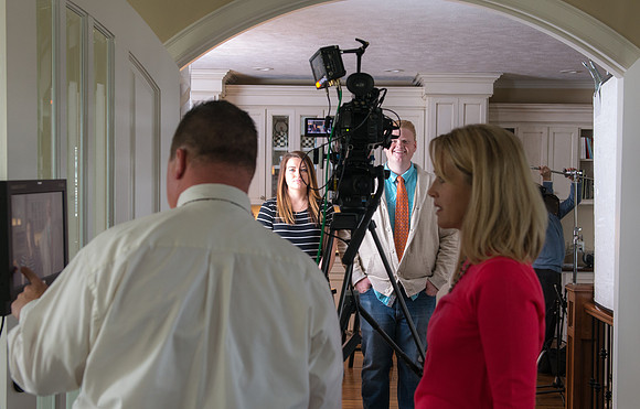 Video crew prepping for a video with President and Sister Gilbert.