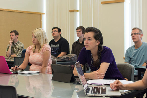 Design students go over their projects in Identity Design with instructor Scott Franson. These projects cover the use of logos and images in businesses.