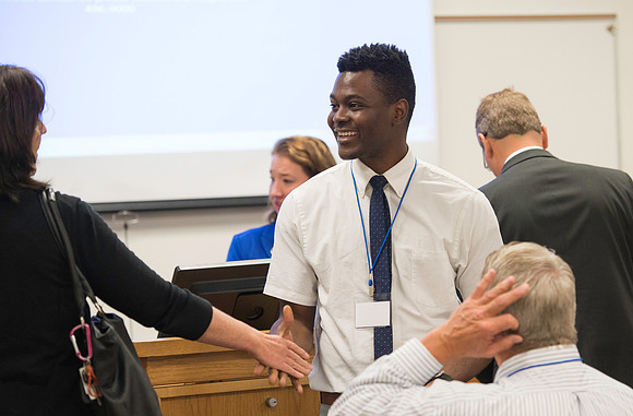 Faculty gather in the Hinckley Building for a conference to learn from their peers. IInternational student Paul Adah