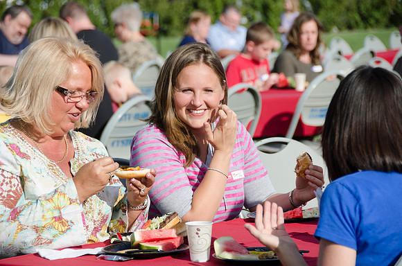 Online instructors gather with their families for an eveing of BBQ and games.