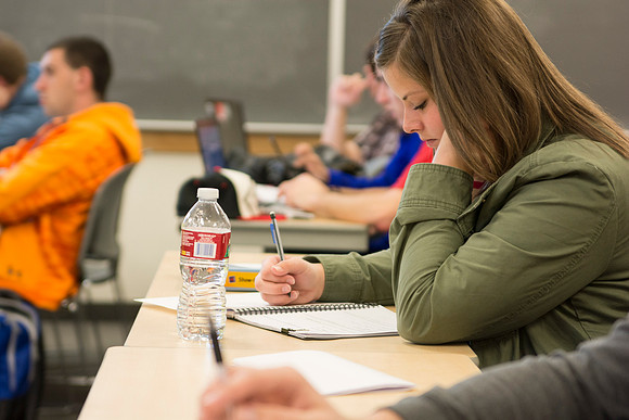 A student in Brother Johanson's Math 109 Precalculus class takes notes.