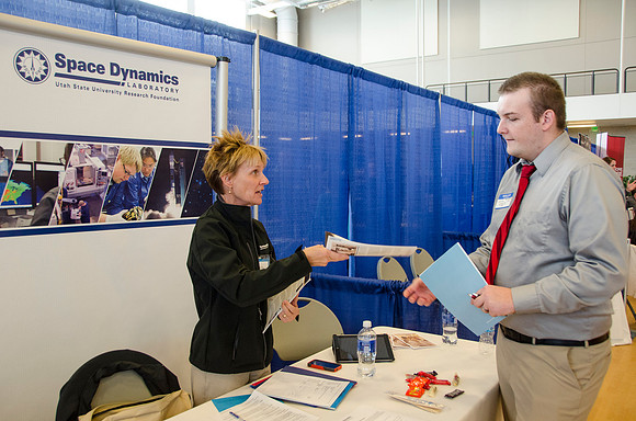 BYU-Idaho students speak to representatives from colleges or companies from their field of study at a career fair held in the I-Center gym