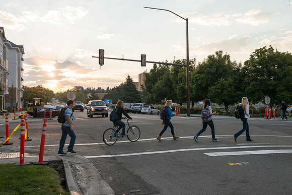 Students are welcomed back to school with a beautiful morning and a warm breeze as they walk to campus.