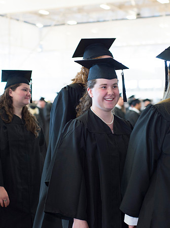 Graduates wait inside the gym area preparing to enter Commencement ceremony.