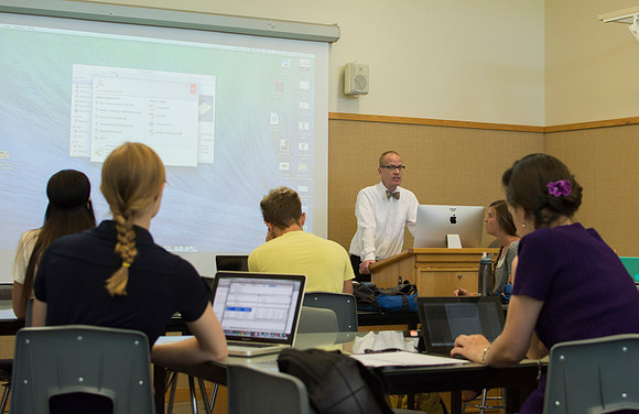 Design students go over their projects in Identity Design with instructor Scott Franson. These projects cover the use of logos and images in businesses.