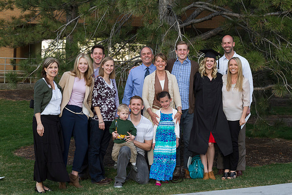 A 2014 Winter graduate smiles with her family after the Commencement Ceremony in the I-Center during the 2014 Winter Graduation.
