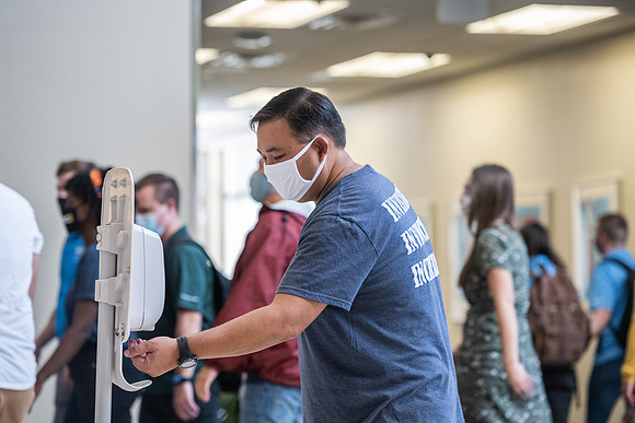 Students use hand sanitizer on campus to stay safe and healthy.