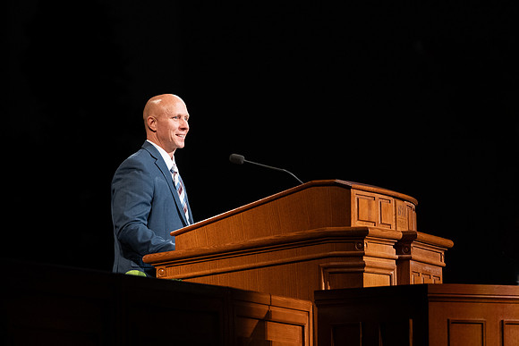 Ryan Butters speaks to students at the weekly Tuesday devotional.
