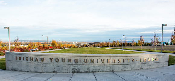 Fall leaves turn colors behind BYU-Idaho sign.