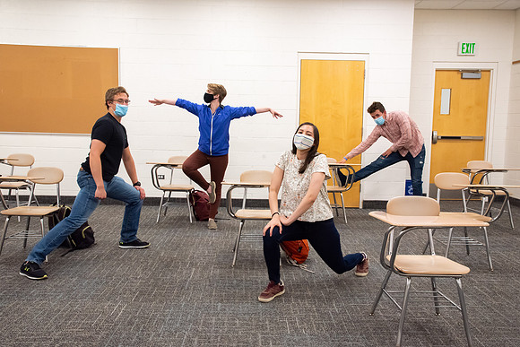 Examples of students staying safe and healthy during the COVID-19 pandemic by social distancing, following pathway arrows, and wearing face masks.