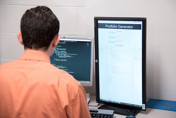 Employees work on developing a better curriculum for online students.