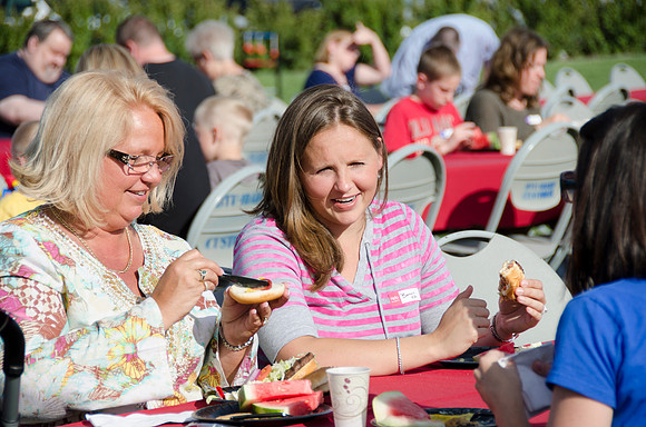 Online instructors gather with their families for an eveing of BBQ and games.