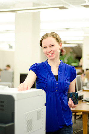 A student waits for her copies to be printed.