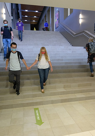 Student volunteers show the way to stay safe during this COVID 19 pandemic by social distancing, following pathway arrows and proper wearing of masks .