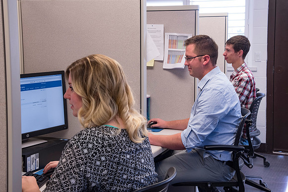 Employees work on developing a better curriculum for online students.