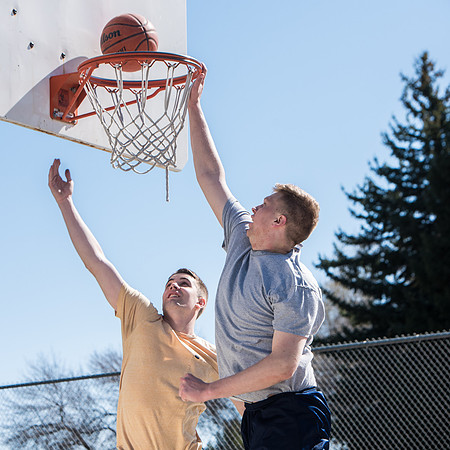 Jacob and Jacob, two BYU-Idaho students, play one on one basketball at the Smith Park court.