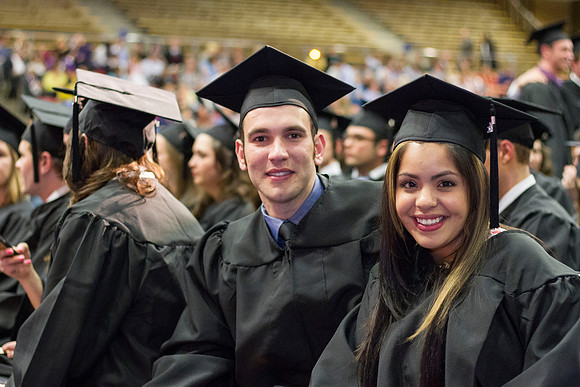 Business and Communication graduates smile for picture in the Hart Auditorium during the 2014 Winter Semester Convocation.