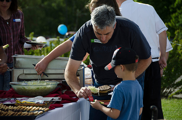 Online instructors gather with their families for an eveing of BBQ and games.
