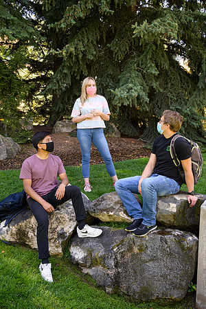 Student volunteers show the way to stay safe during this COVID 19 pandemic by social distancing, following pathway arrows and proper wearing of masks .