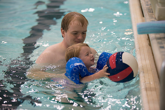A family enjoys time together in the pool.