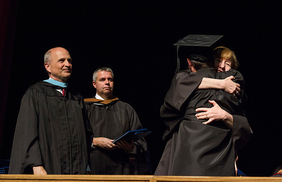 Robyn H. Bergstorm, Dean of the Business and Communication College congratulates a fellow student during Convocation in the Hart Auditorium.