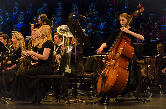 Members of the Collegiate Singers, Men's Choir, Women's Choir, and Symphony Band all perform together at the Patriots and Pioneers Concert.