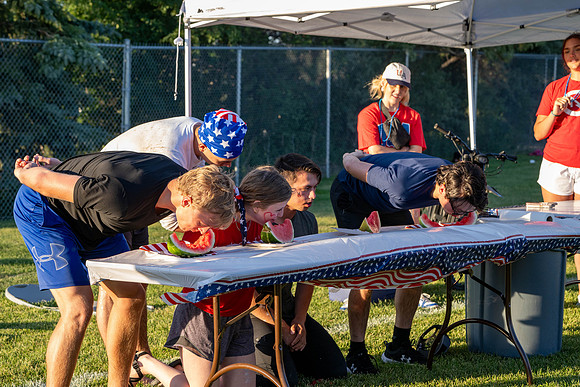 Students gather at the upper field for various 4th of July activities.