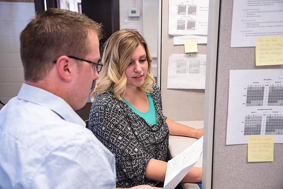 Employees work on developing a better curriculum for online students.