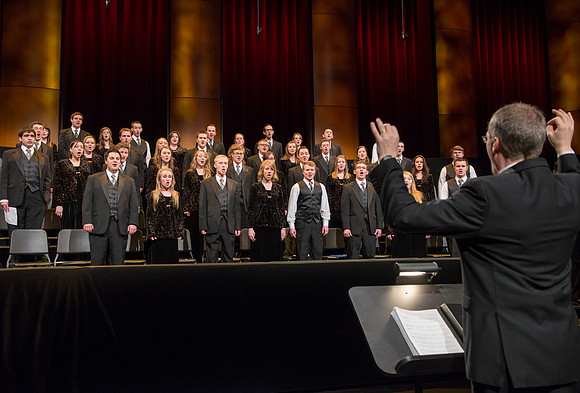 Randall Kempton rehearses with the Collegiate Singers in the BYU-Idaho Center before devotional.