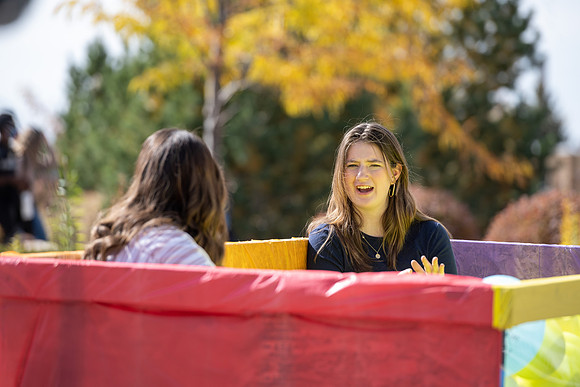 Students who volunteer to participate sit in the ball pit and ask each other questions which are found on the balloons. Video is being produced for Student Living.